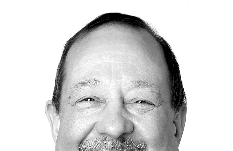 A person is smiling at the camera. We can see their eyes and nose, but the photo is cropped above their mouth.